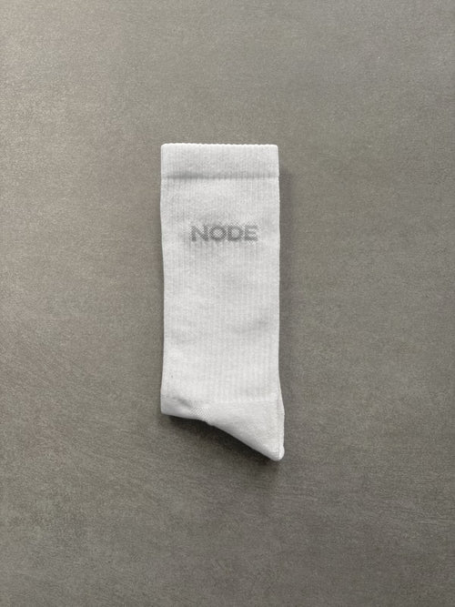 White sock with 'NODE' branding on a grey background