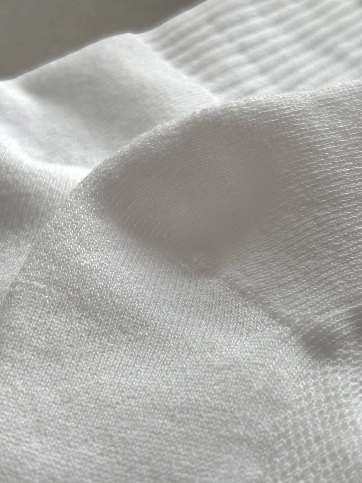 Close-up of cushion sock heel and white fabric 