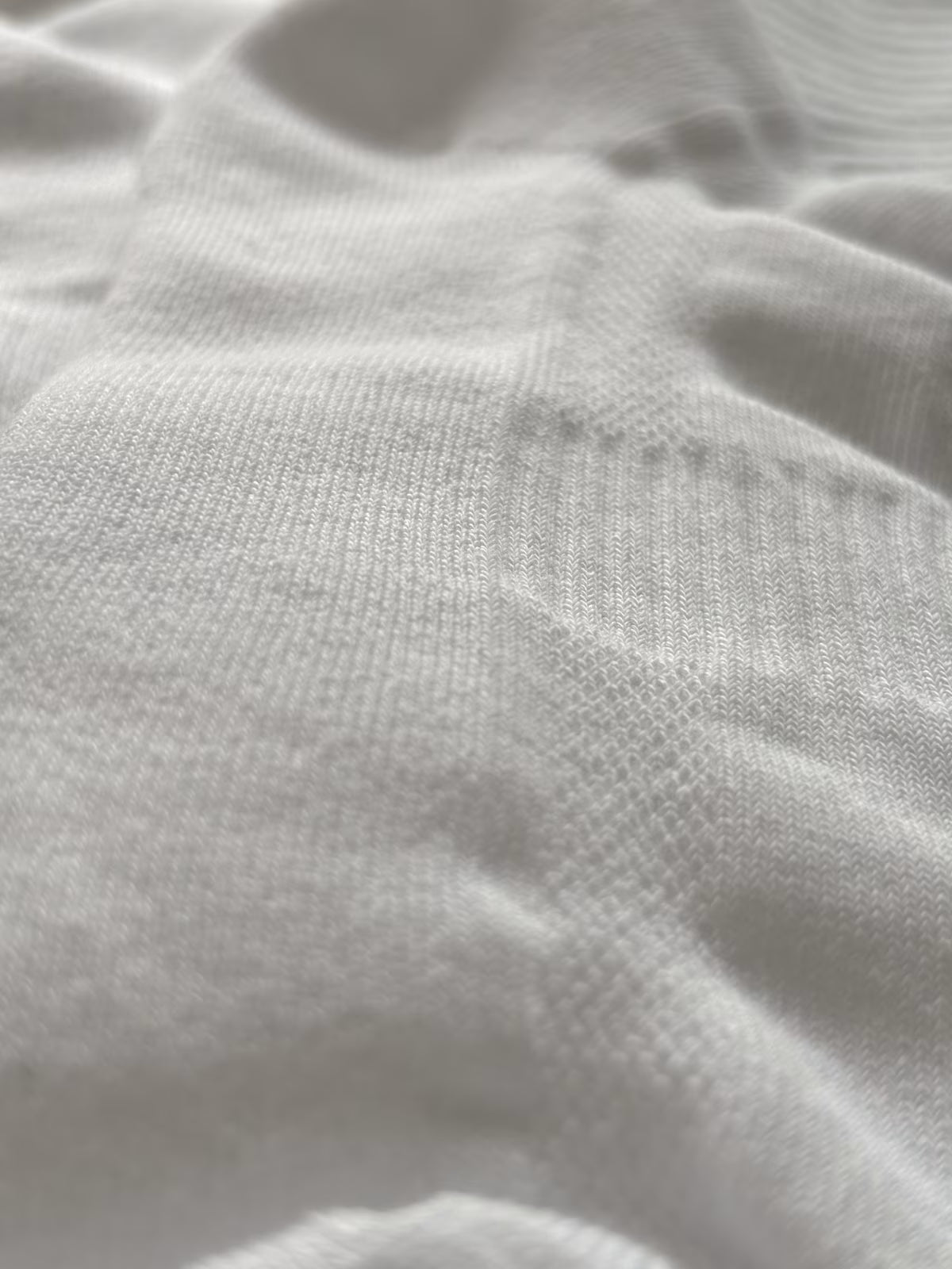 Close-up of textured arch support and white fabric